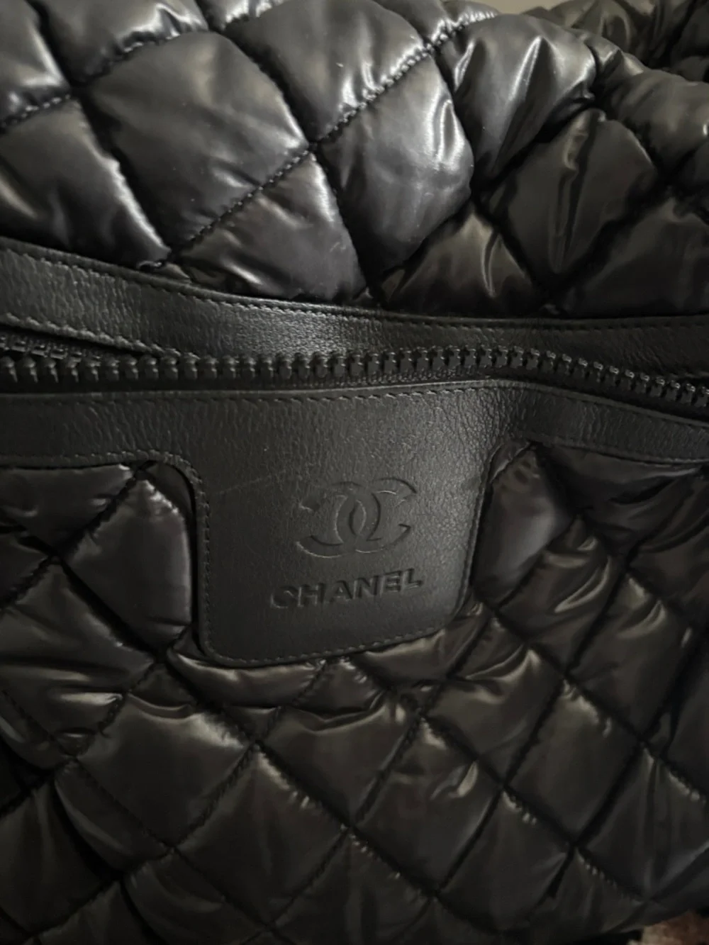 CHANEL Black Quilted Puffer Bag with Embossed CC Patch